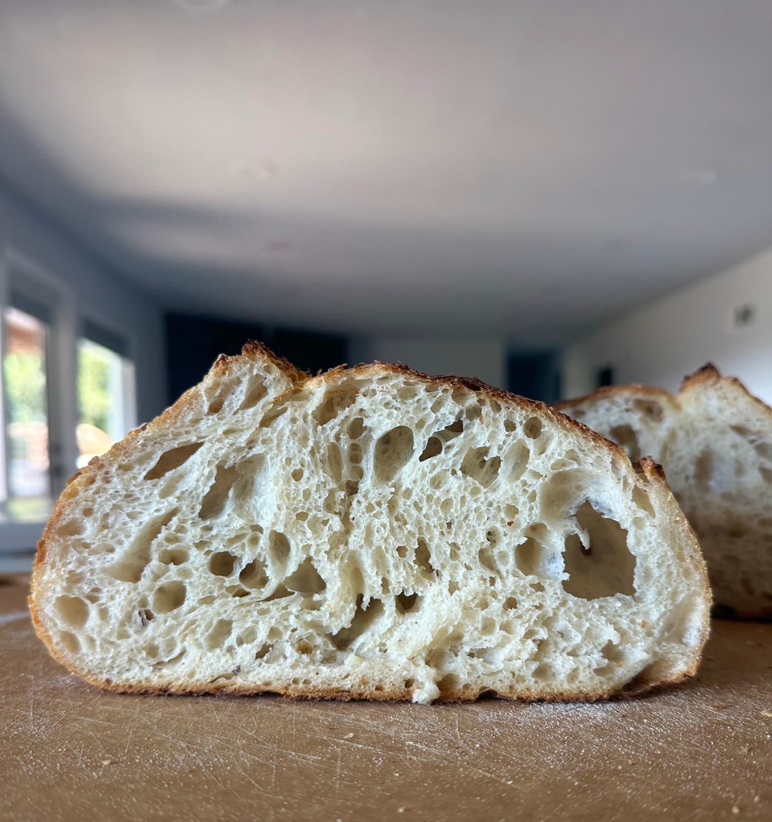 Hands shaping dough during a sourdough class